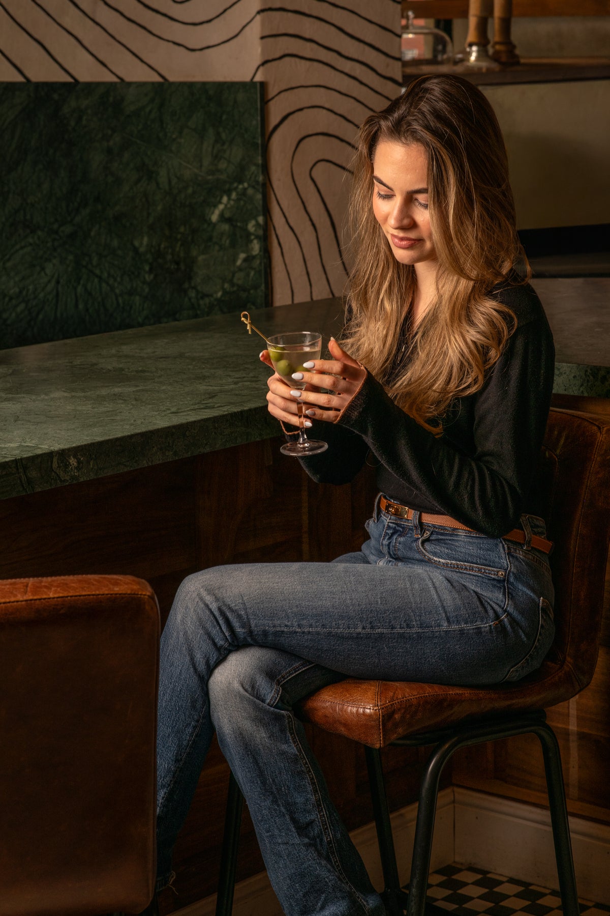 Cocktail at Fiena's green marble bar, a natural after-work perch